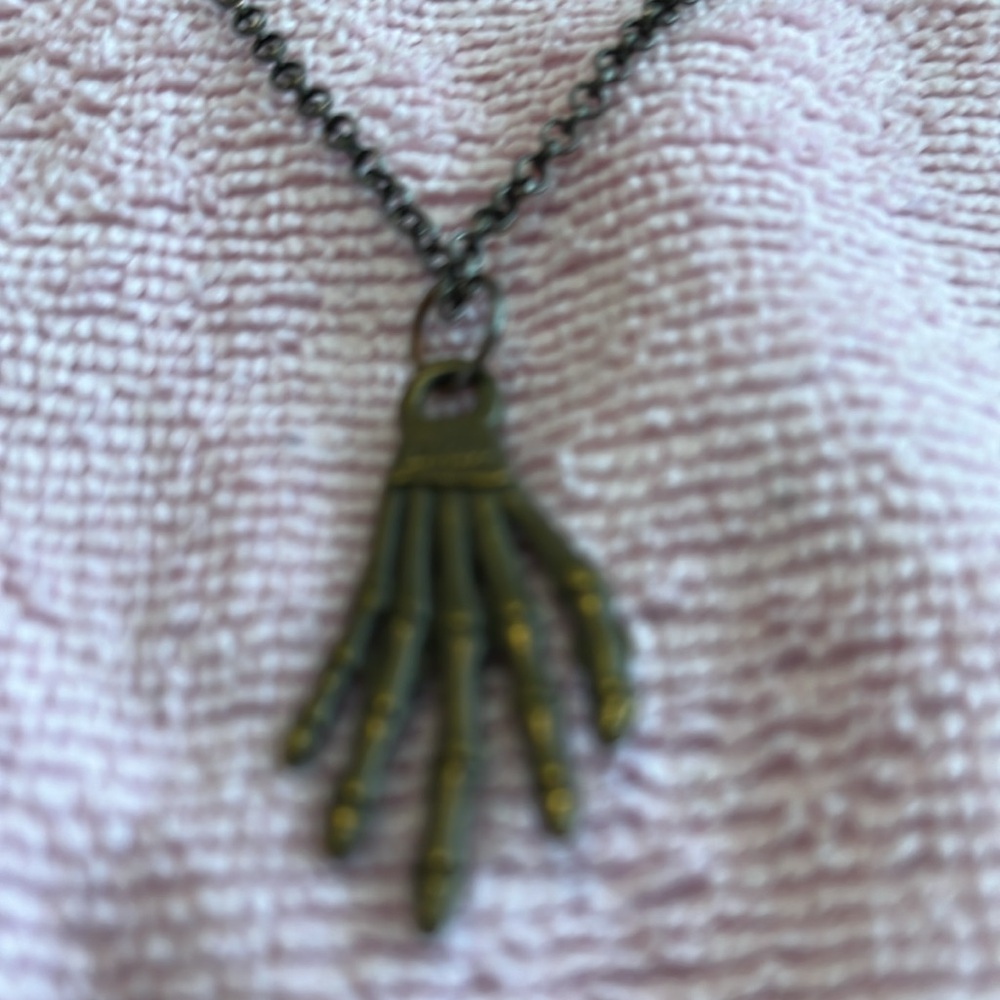 Necklace: witch’s hand pendant. Black beads on second strand on gunmetal chain